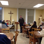 Father Eduardo speaking to the sisters